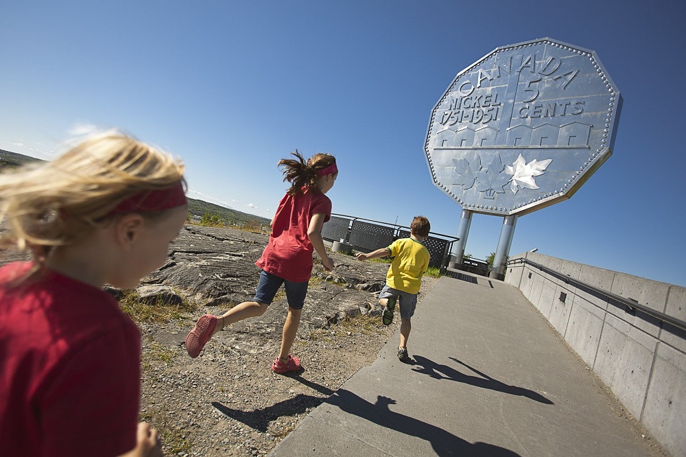 kids running towards the Big Nickel