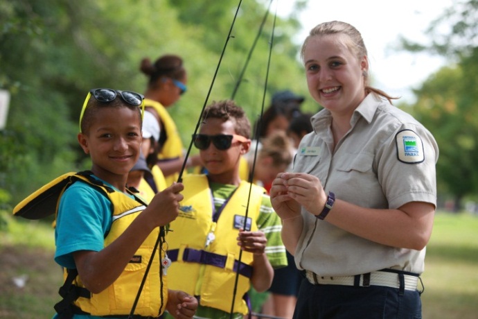 A Learn to Fish employee teaching children to fish