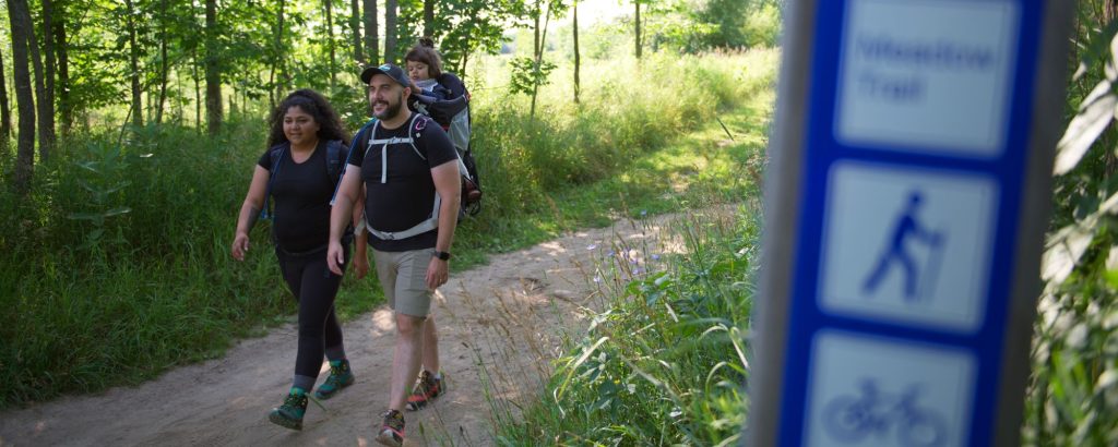 family hiking on trail