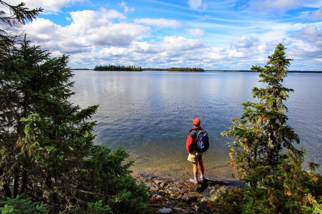 person standing at edge of lake