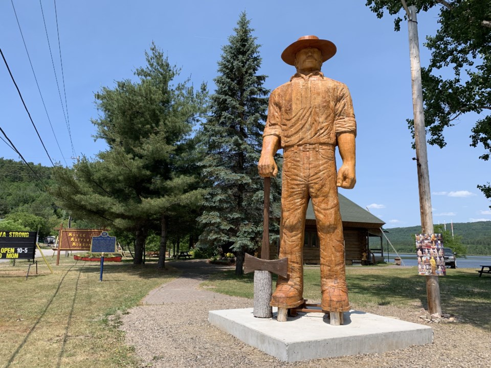 large wooden statue of Big Joe Mufferaw, a man in a hat holding an axe