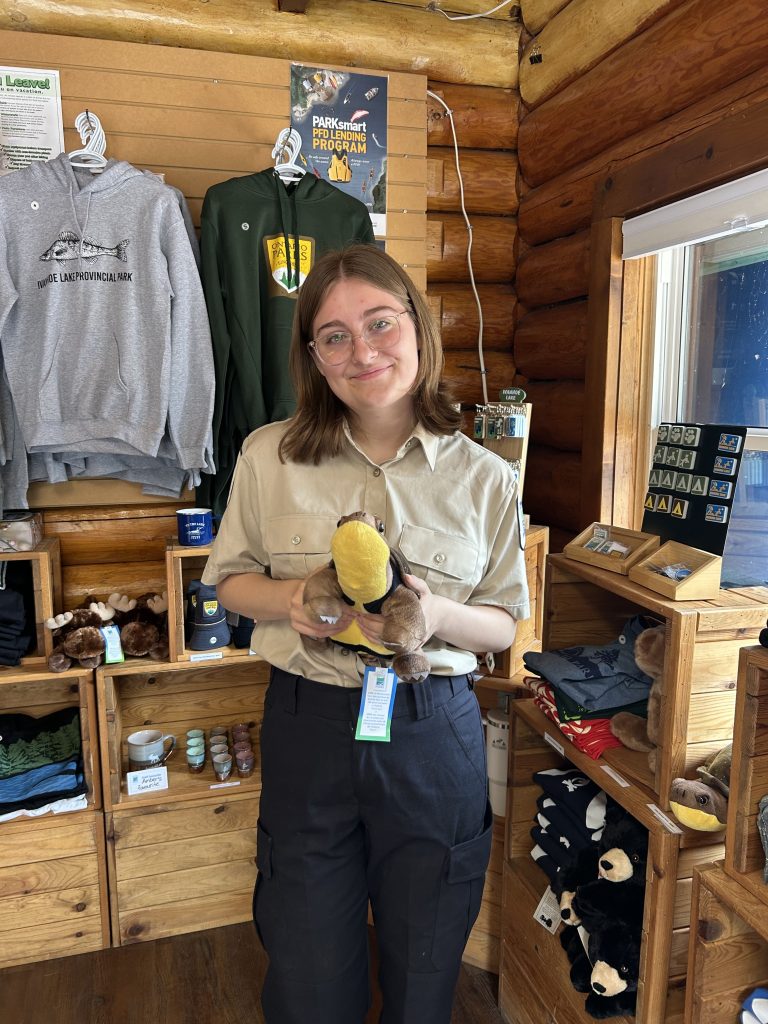 Erika inside park gate, holding Blandings Turtle plushie