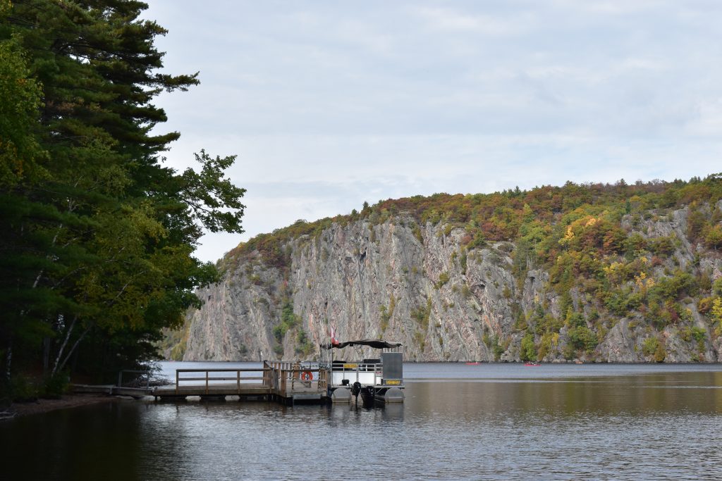boat at dock with Mazinaw Rock in background