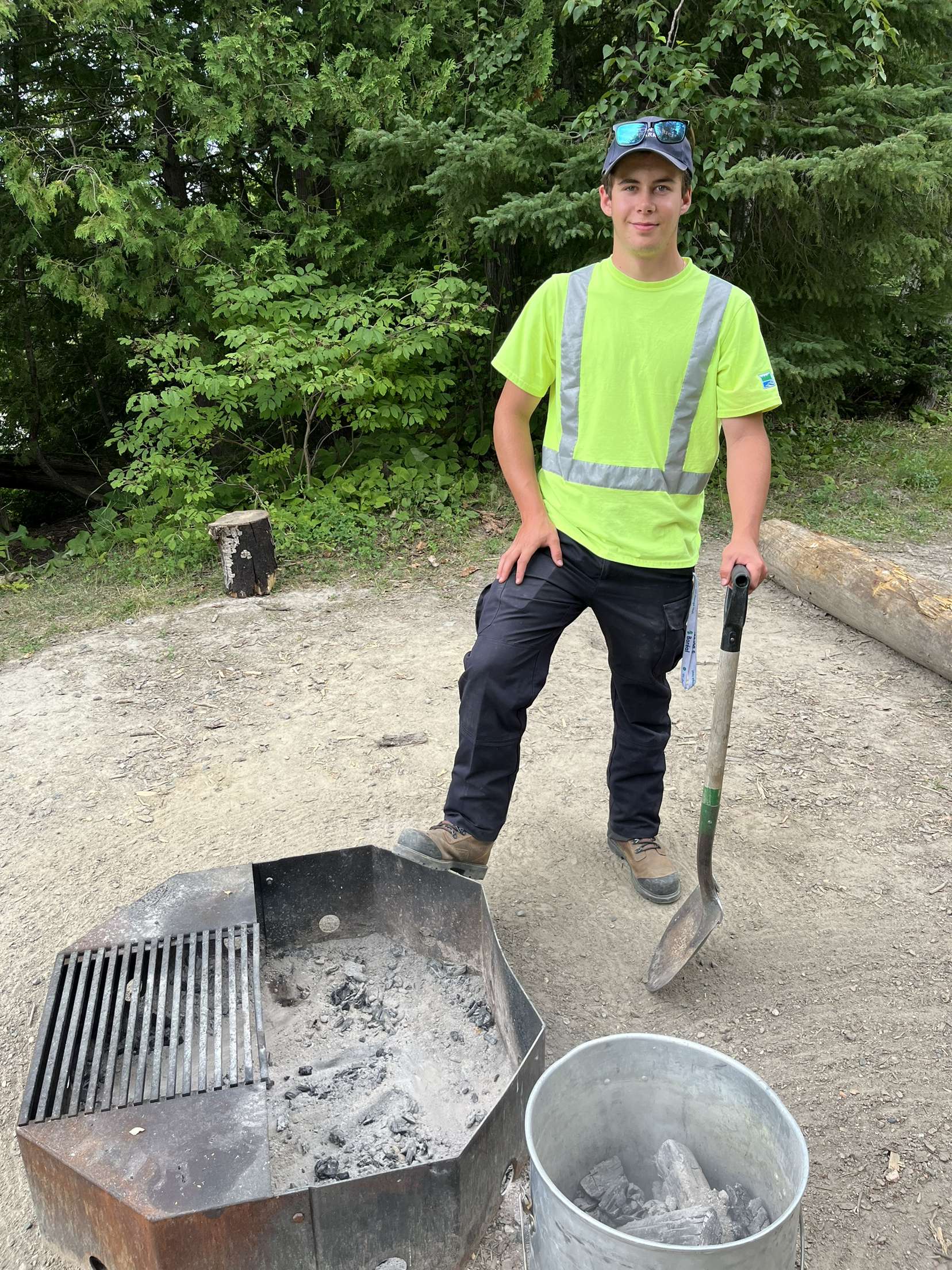 staff standing next to fire pit