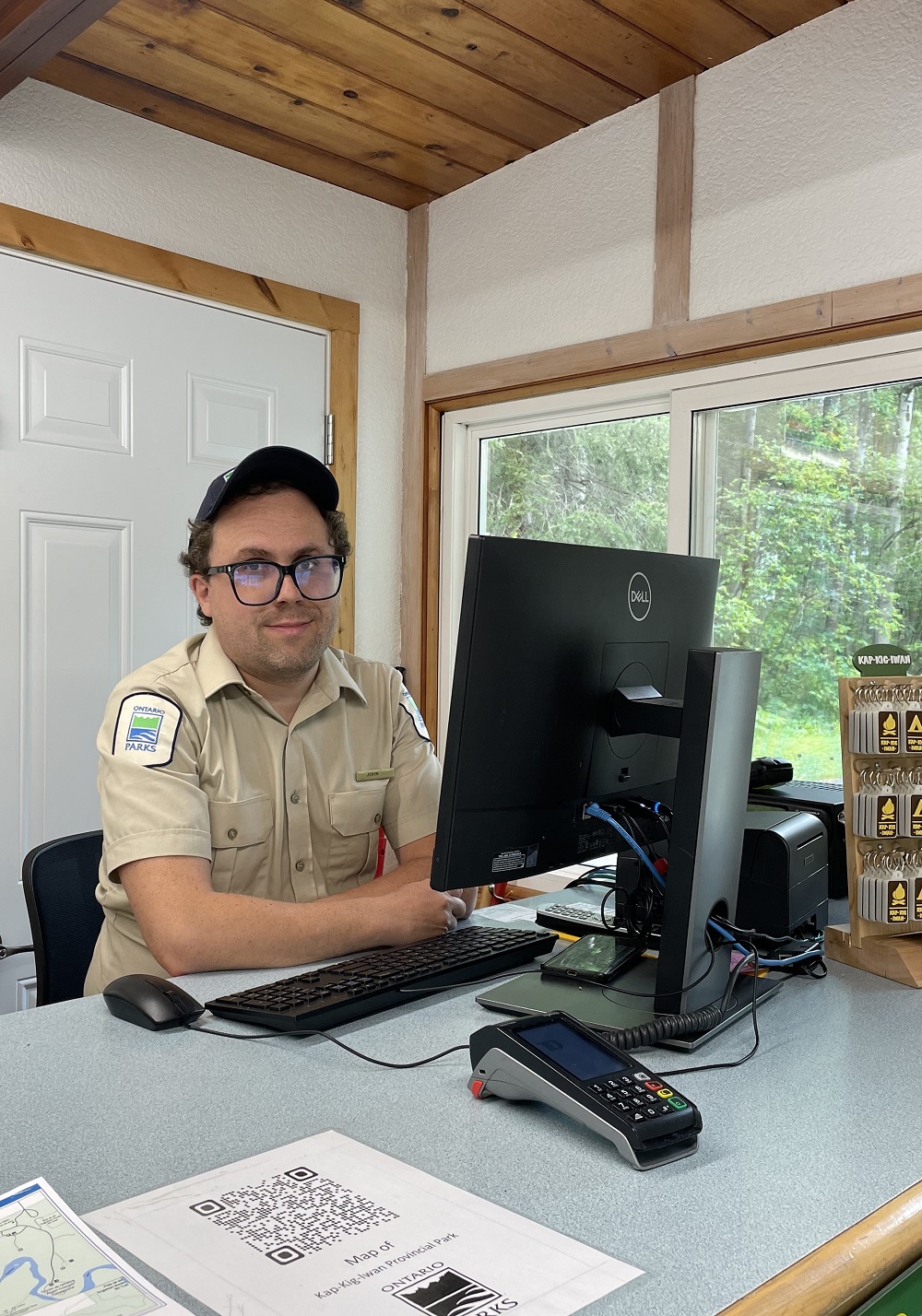 staff sitting behind desk at computer