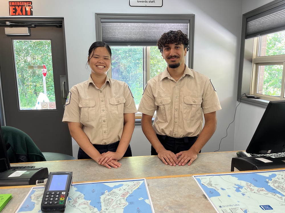 two staff standing behind desk