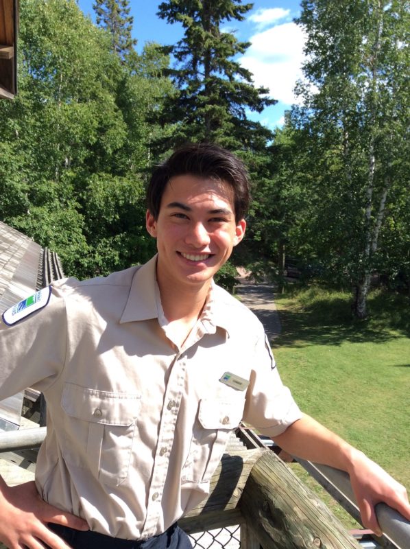 ranger stnading in front of trees