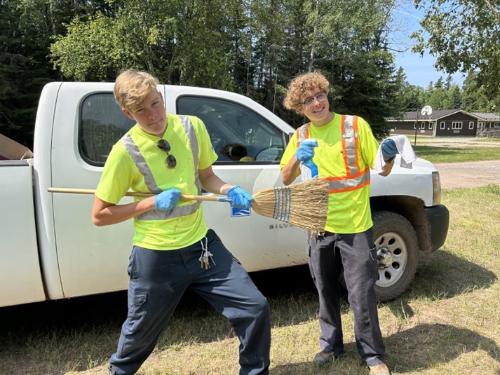 staff members wearing high vis, posing with cleaning equipment