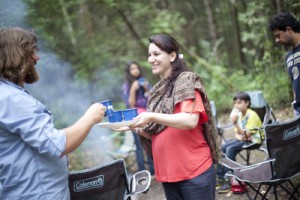 woman filling cup at cookout