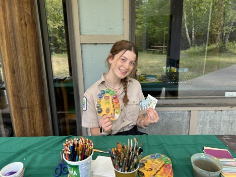 staff holding art supplies