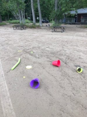 plastic buckets and shovels discarded on the beach