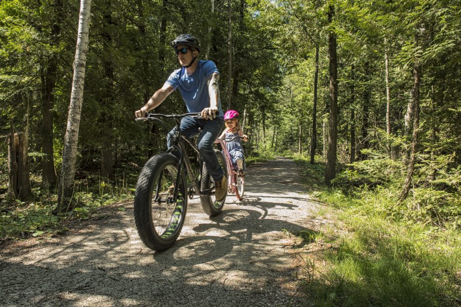 man and child biking