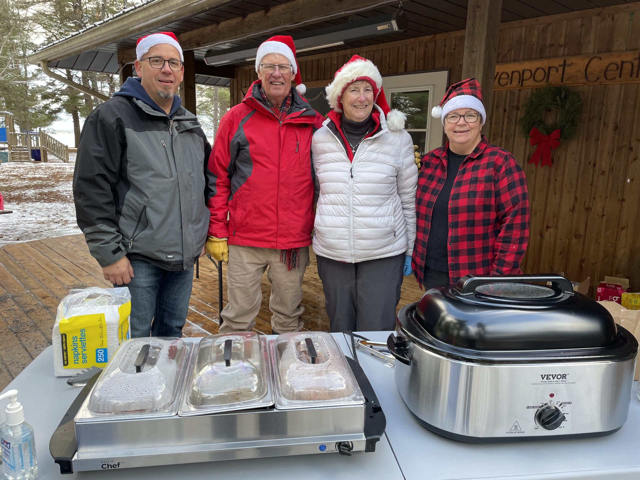 volunteers wearing Santa hats at the refreshment station