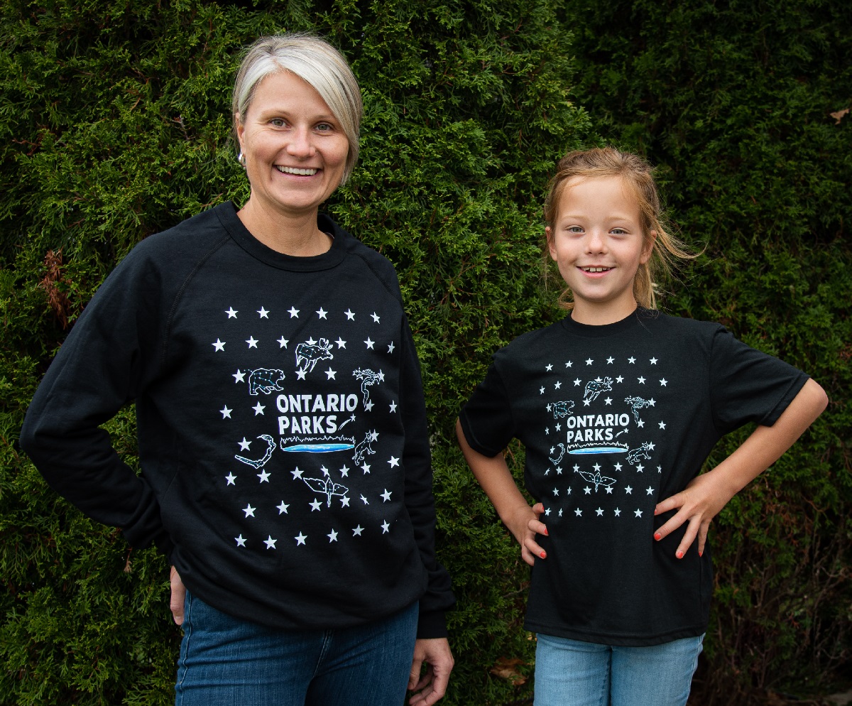 parent and child wearing black shirts with white stars and "Ontario Parks"