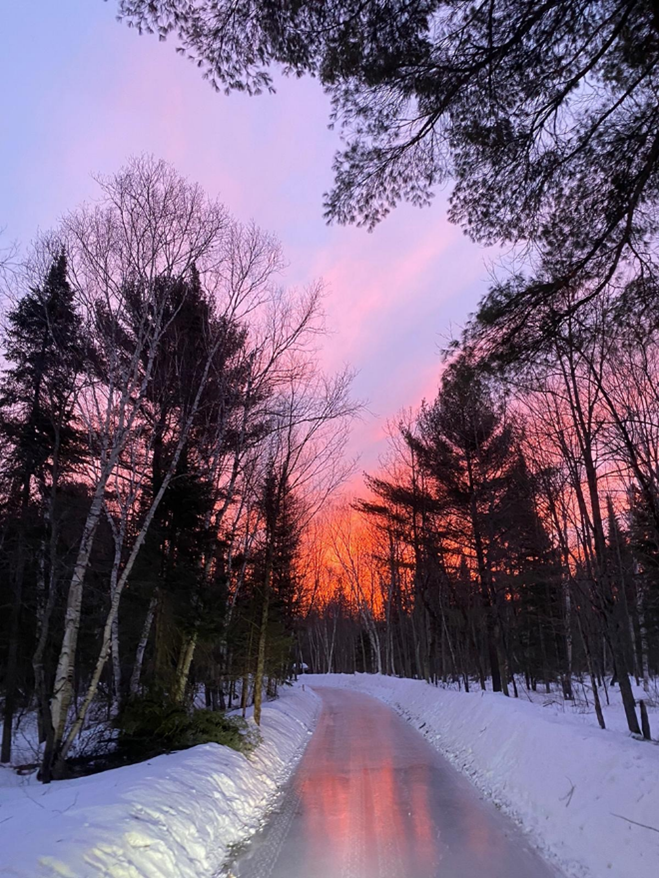 ice trail at sunrise in snowy forest