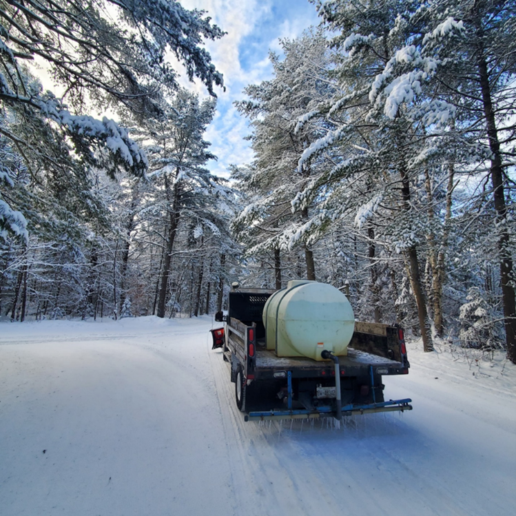 zamboni pouring water on winter trail