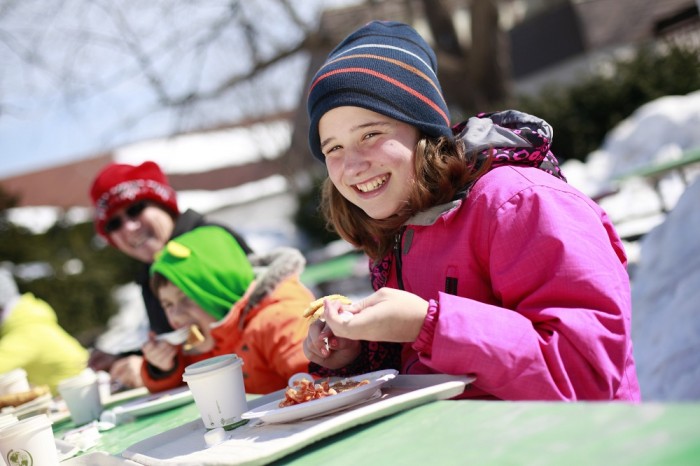 girl eating maple treat