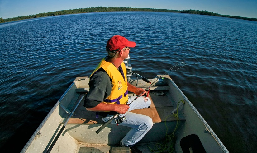 A fisherman in a boat on a lake