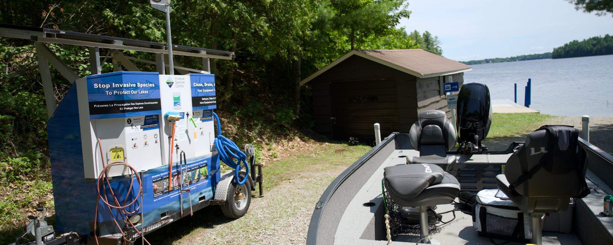 boat wash station and boat in front of lake at park
