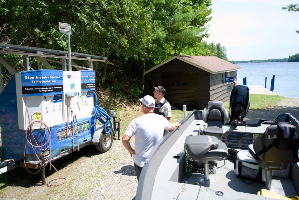 Park staff and boater looking at boat wash station