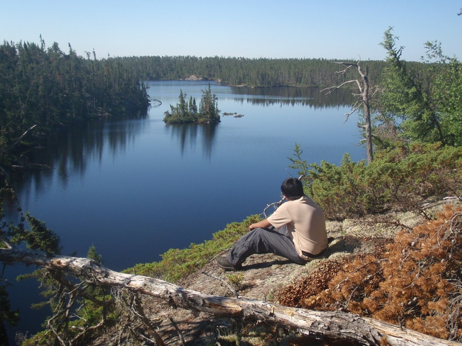 hiker looking down at lake