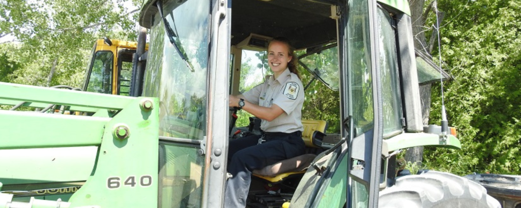 Rachel, an Ontario Parks operations technician, in a tractor
