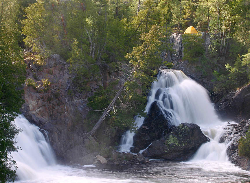 campsite beside waterfall