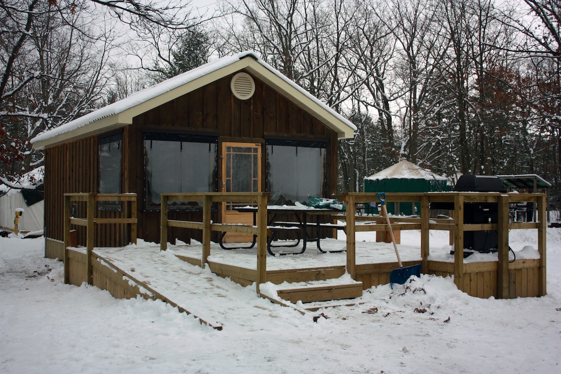 A cabin in a snowy forest at Pinery Provincial Park