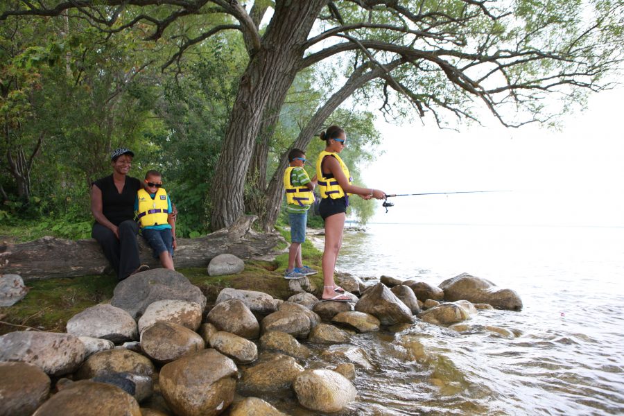 family fishing on shoreline