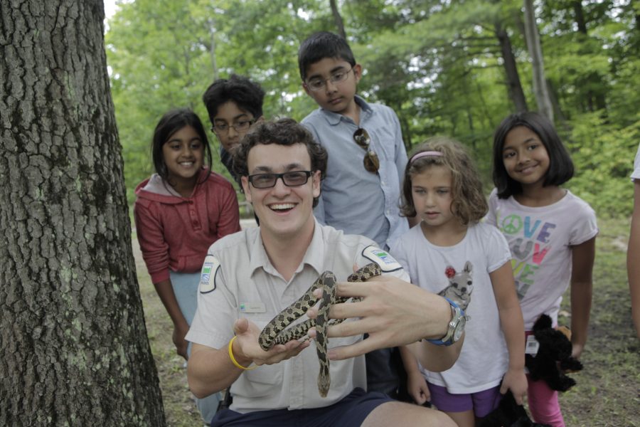 NHE leader holding snake