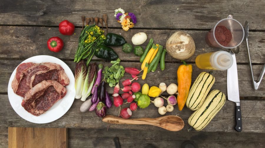 ribeye steak and vegetables on picnic table