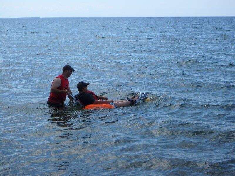 wheelchair being pushed through water