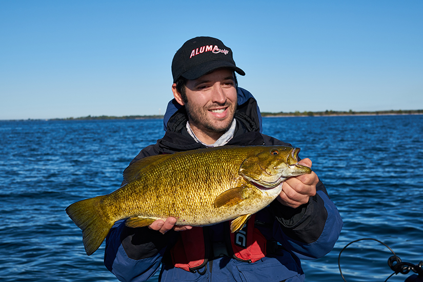 Man holds up large bass