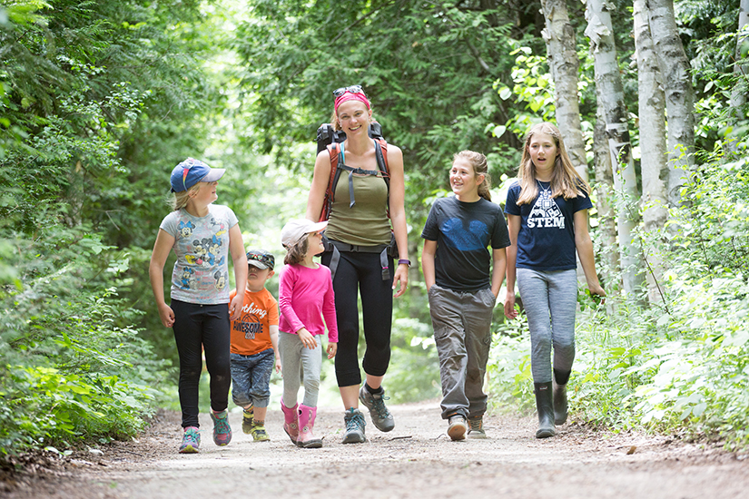 Teacher and students walking down trail