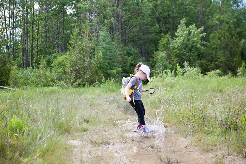 Child playing in a puddle