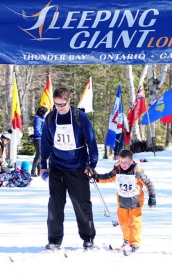 Father and son with finish line in the back