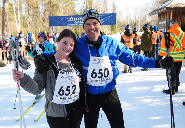 Father and daughter in ski outfits