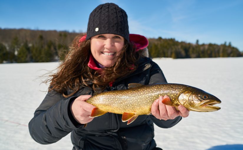 Woman holds lake trout