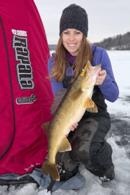 Ashley holds a walleye on the ice