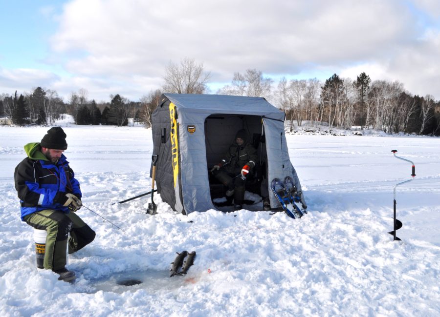 Man ice fishes on Windy lake