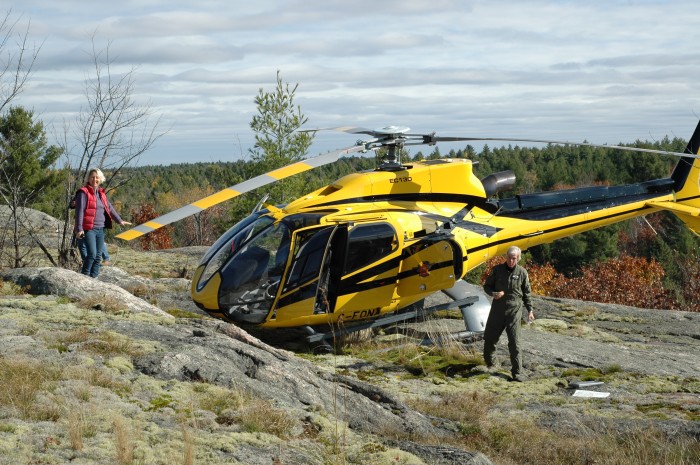 Sandy White next to helicopter