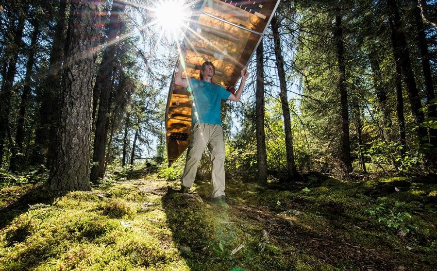 Man portaging a canoe