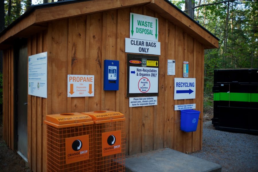 Wood cabin exterior with waste facilities and information