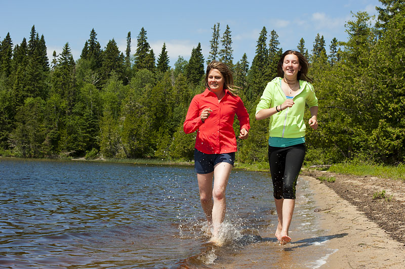 Women run on beach