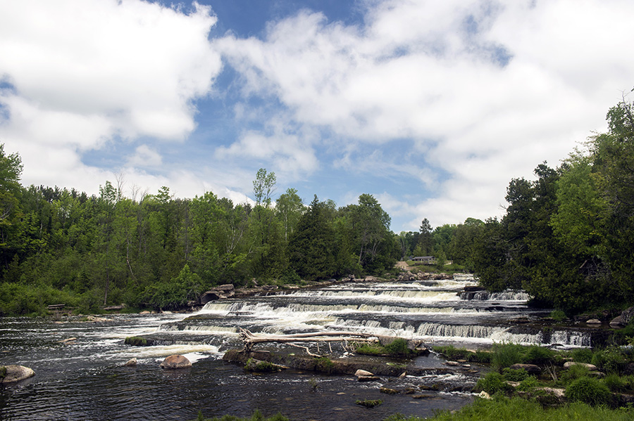 Landscape of waterfalls and trees with blue sky