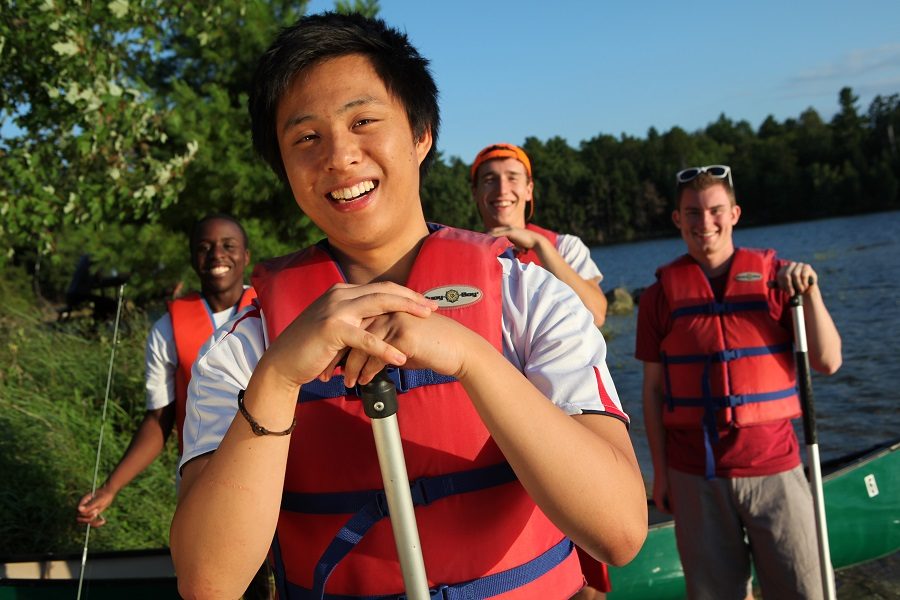 Group of men in lifejackets holding paddles