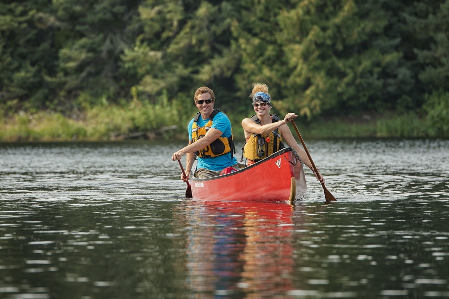 Two people paddling a red canoe in Wabakimi Provincial Park