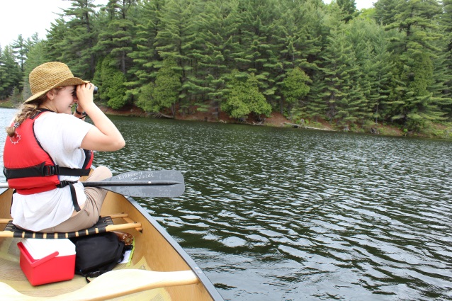 woman looking through binoculars