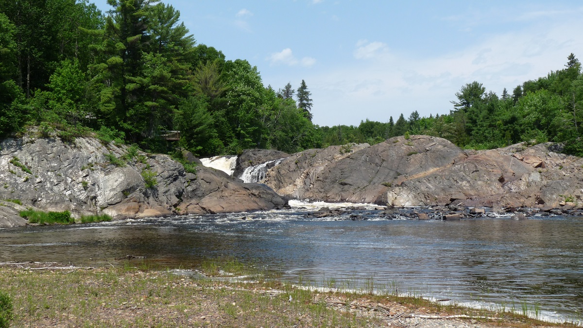 Waterfall through rocks with water pooling in the foreground