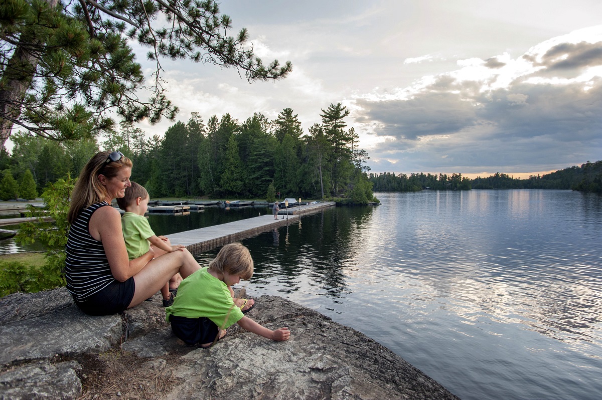 Woman and two children overlooking the lake from the shore